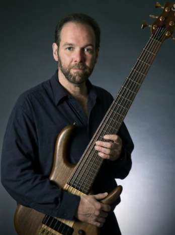 David Hines holding electric bass.